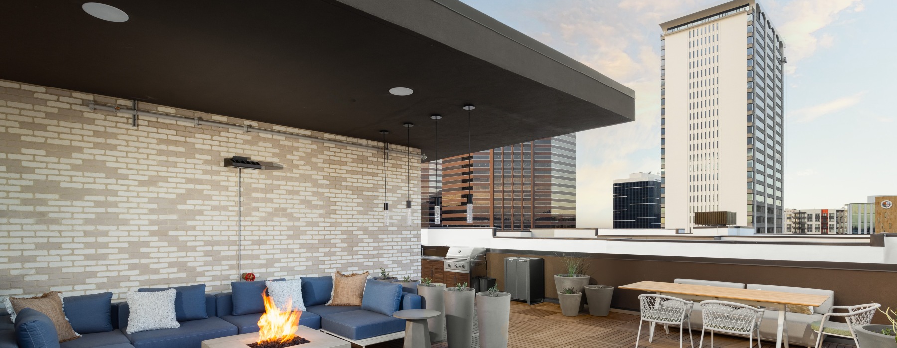 a rooftop view with couches and bar ledge